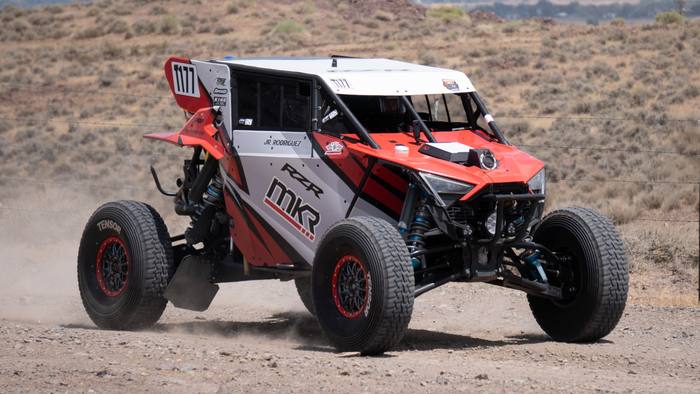 UTV race vehicle number 1177 at speed, Polaris RZR