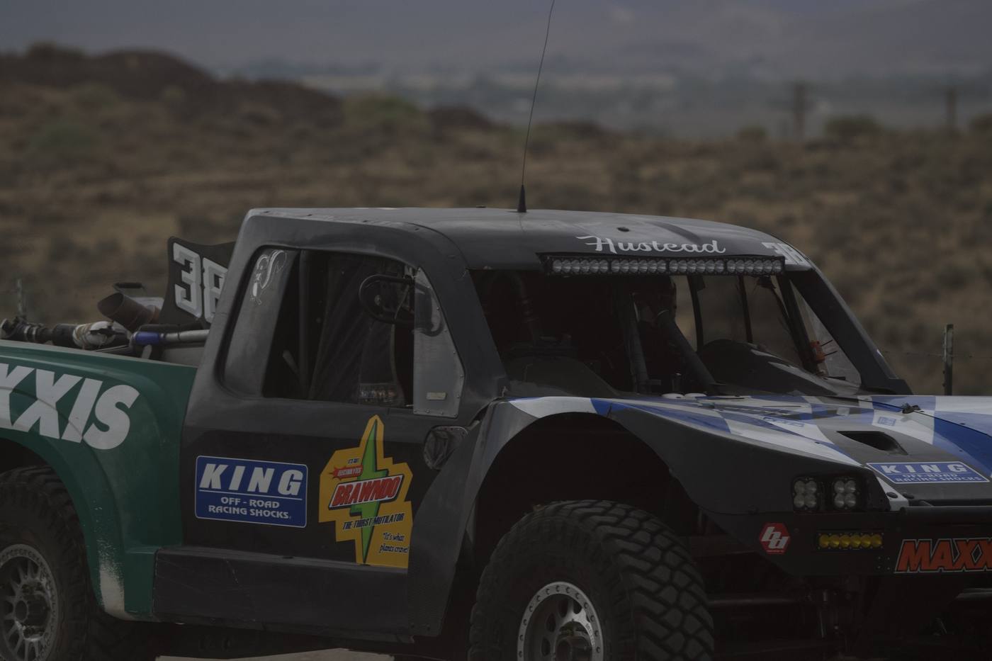 A tight crop of a race truck cab and sponsor decals